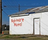 Nightmare Hotel. Vacancy. Written in blood, funny building side sign.